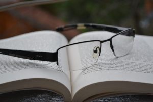 reading glasses resting on a book