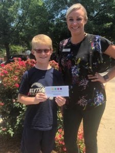 color blind boy wearing EnChroma glasses with female optician